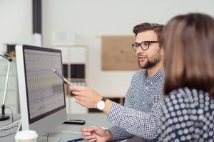 male employee  checking his erp software before going live
